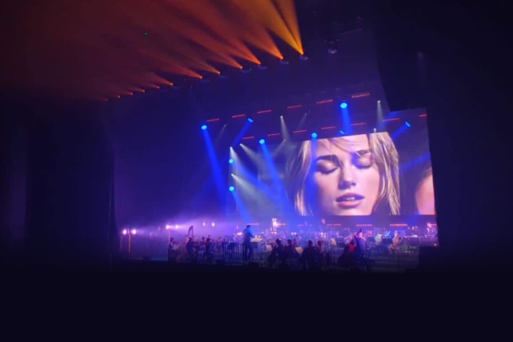 Zdjęcie z koncertu. Na scenie kadr z jednego z prezentowanych filmów.