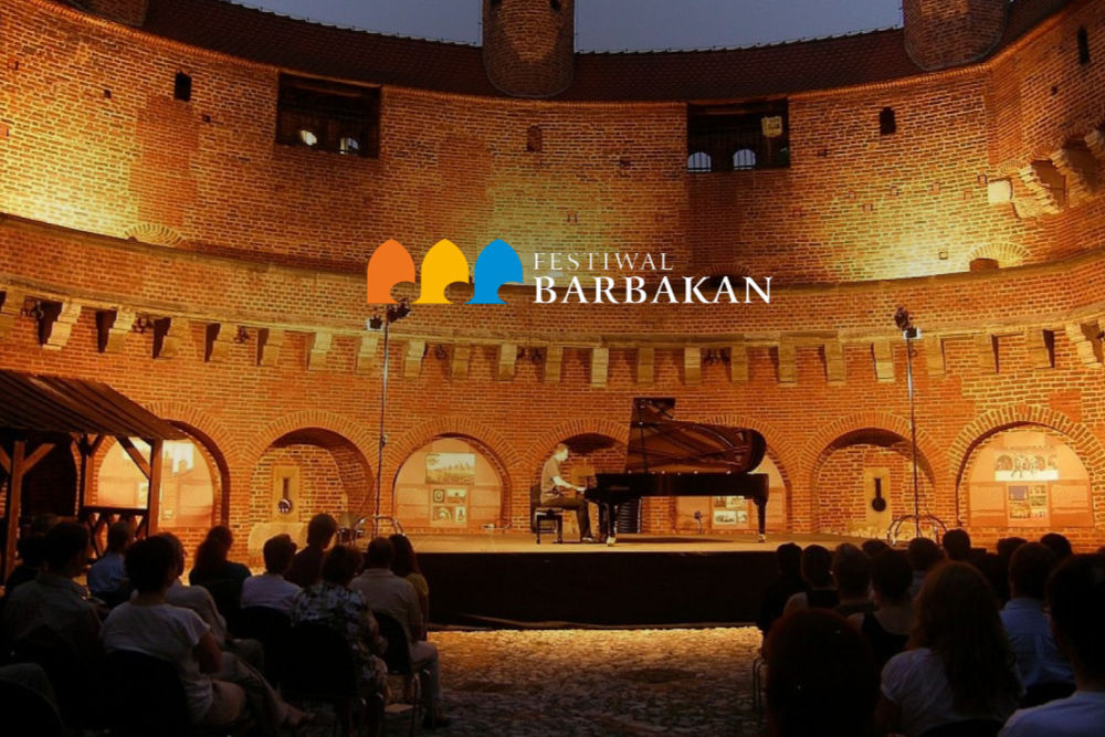 Fotografia przedstawiająca Wnętrze Barbakanu a w nim scenę. Na scenie pianista gra na fortepianie